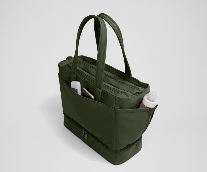 Exterior front pocket packed with hand sanitizer and a phone. Exterior bottle pocket packed with a milk bottle