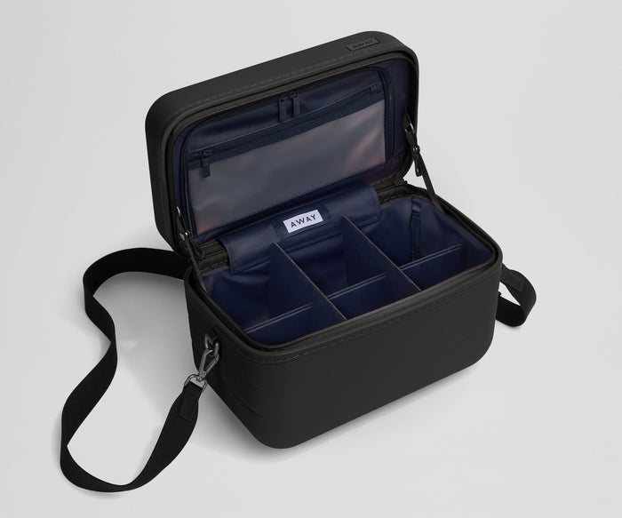 Removable fabric dividers in an empty Train Case
// Includes three wipeable and removable fabric dividers that can create four to six compartments to accommodate a variety of items and organization solutions.